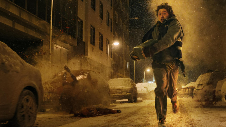 Austin Abrams as Bryan running down the street as bodies explode around him in Resident Evil (2026)