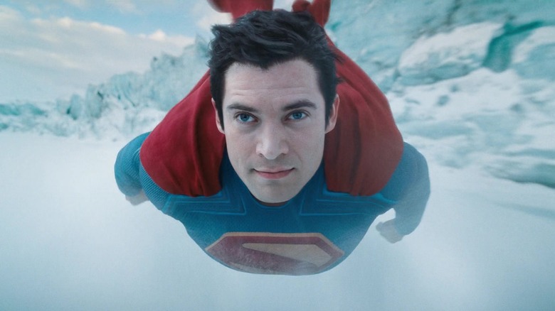 David Corenswet's Superman flies over a snowy landscape in Superman
