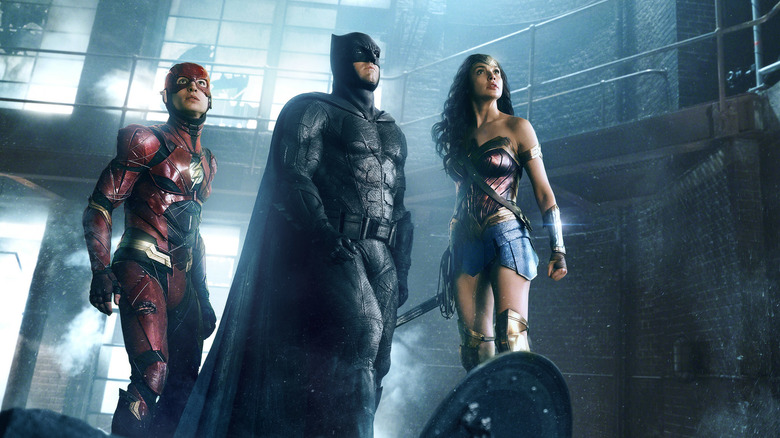 The Flash, Batman, and Wonder Woman looking up in Justice League.