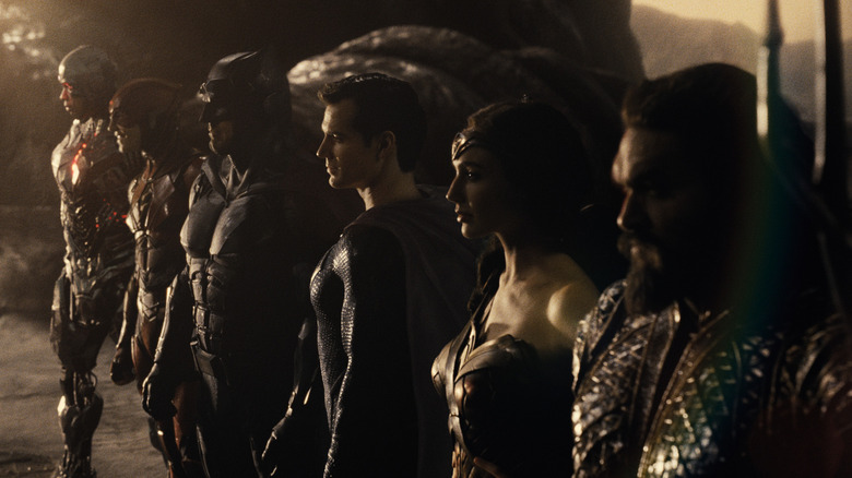 The Justice League members standing in a line, facing their foe
