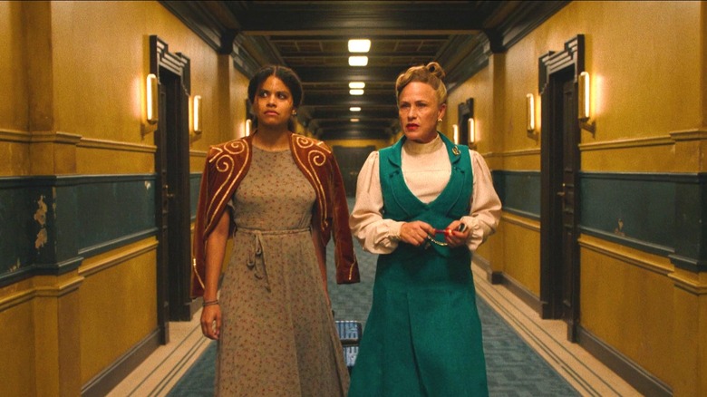 Zazie Beetz as Asia with an ax on fire in the hallway of the hotel in They Will Kill You