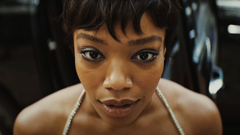 Frida of Naomi Ackie looks excited in close -up in Blink Twice
