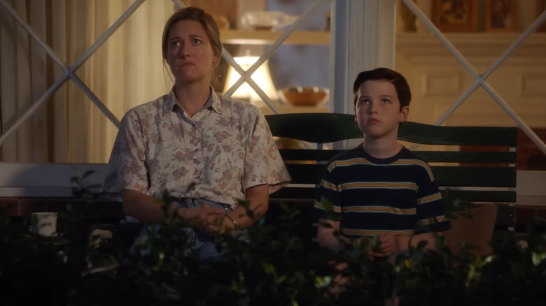 Zoe Perry as Mary Cooper and Iain Armitage as Sheldon Cooper sitting together in Young Sheldon
