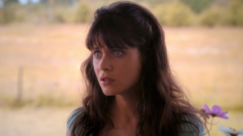ZoEy Deshanel in DG, wears a blue dress and looks shocked, in Tin Man