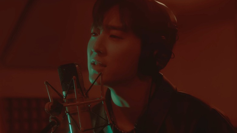 Kevin Woo sings into a mic