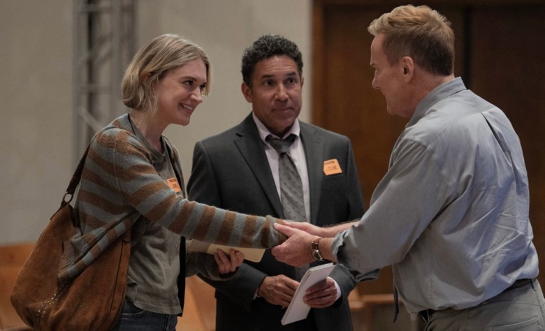 Mare (Chelsea Frie) shakes hands with an interview subject as Oscar (Oscar Nuñez) looks on in The Paper