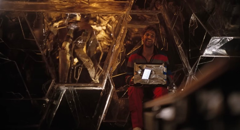 Ryan Gosling as Ryland Grace communicating with Rocky through a window with a computer in Project Hail Mary