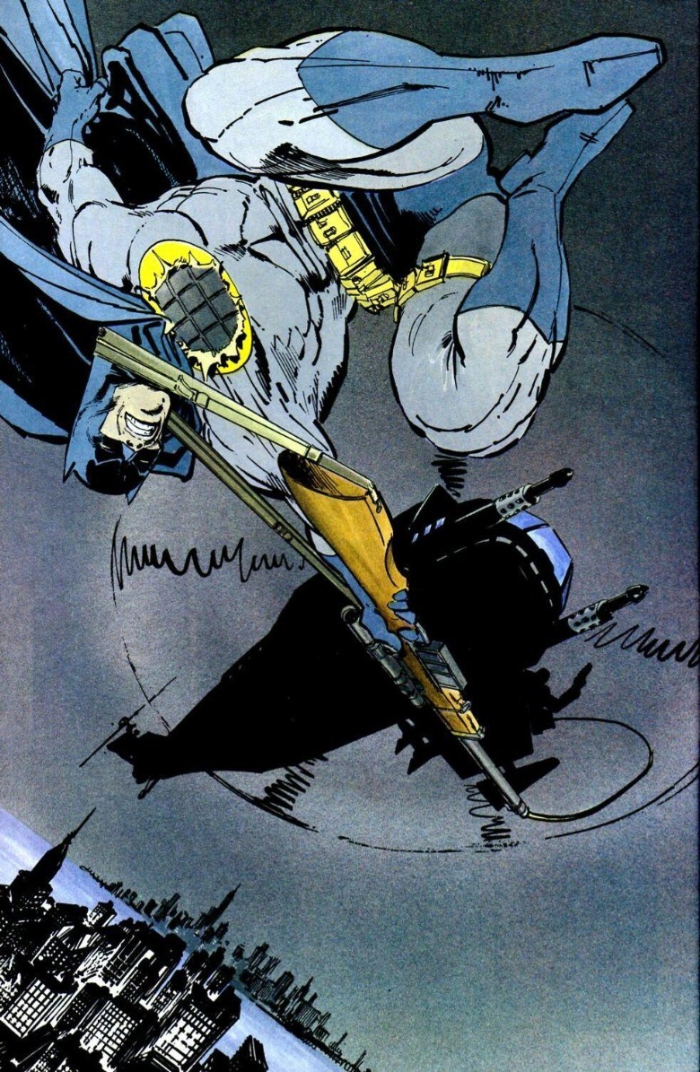 The Dark Knight Returns Batman holding grapple hook rifle dangling from helicopter