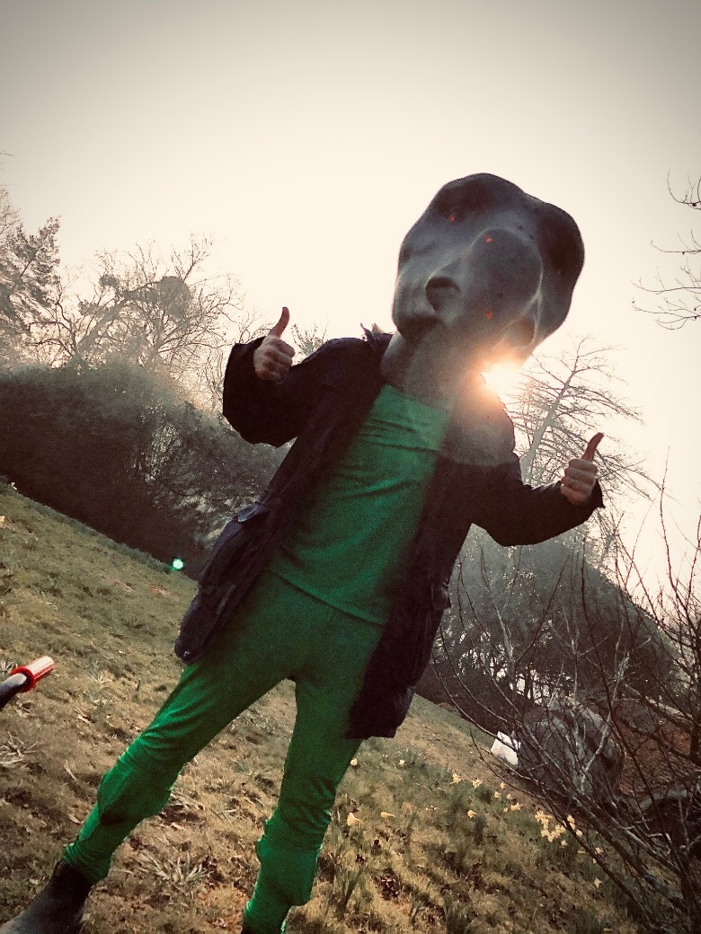 Puppeteer Brian Fisher wearing Gregory head on set.