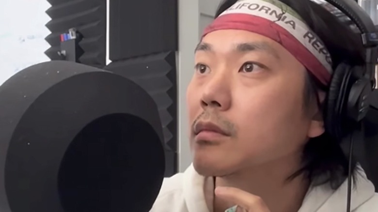 Samuil Lee stands at a mic