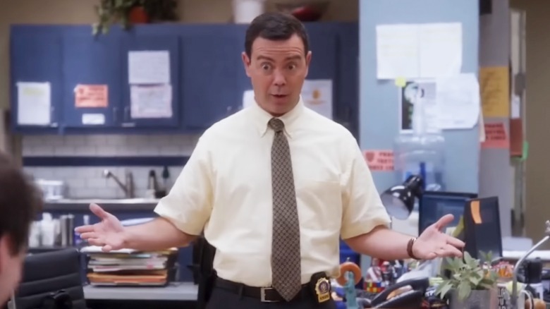 Charles Boyle stands with his arms spread in Brooklyn Nine-Nine