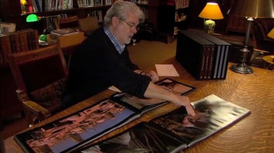 George Lucas looking at Star Wars Frames books