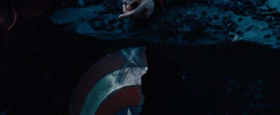 Captain America's shield lays ripped in half in the rubble